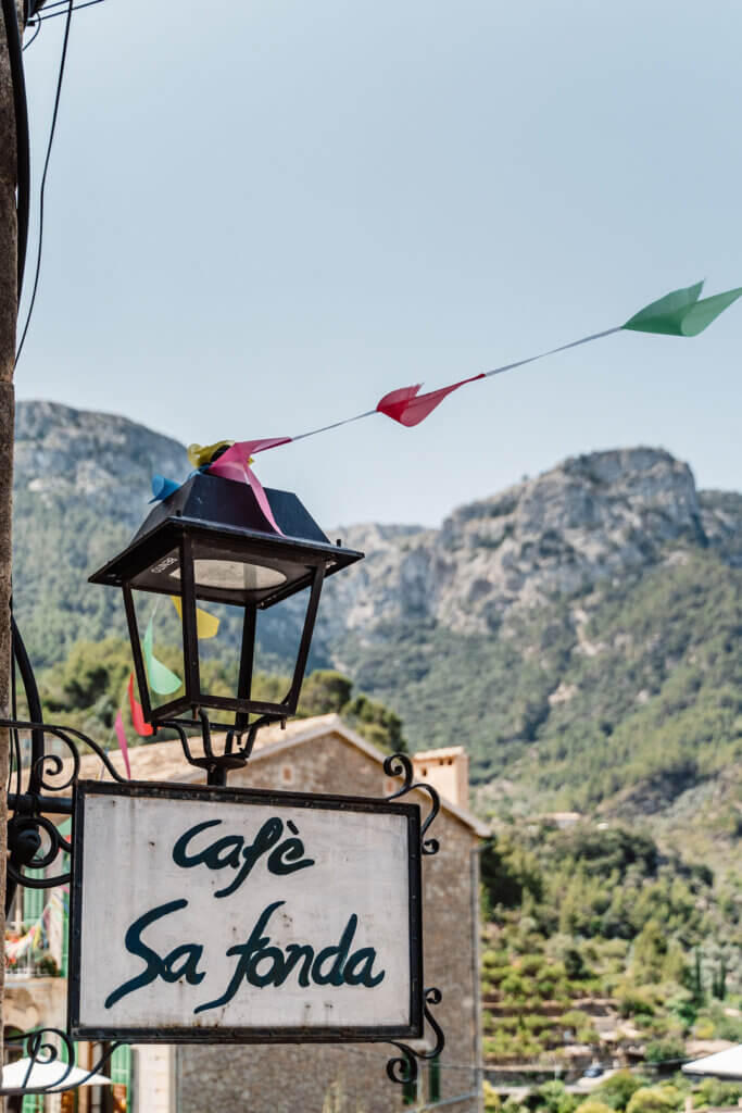 Cafe Sa Fonda sign and mountain view in Deia Mallorca