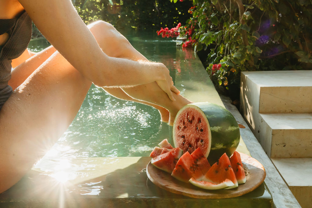 Slices of fresh watermelon by a luxury swimming pool in Mexico