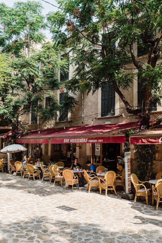 Bar Meriendas café on a shaded village square in Mallorca.