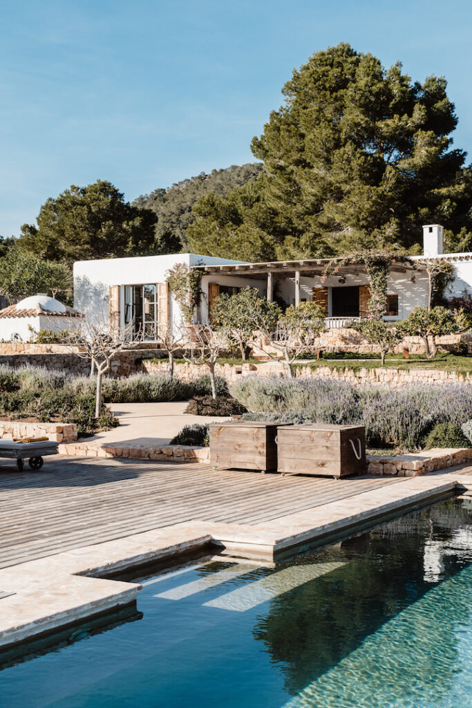 Swimming pool and garden terraces in front of Can Flores Villa in Cap Martinet, Ibiza.