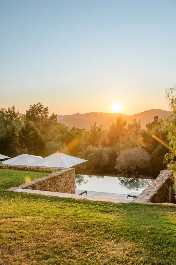 Evening sunset over the swimming pool at Can Zama, a luxury villa in north Ibiza.