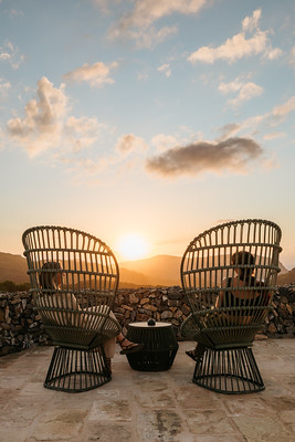 Two woven chairs overlooking the landscape at sunset in the Balearic Islands