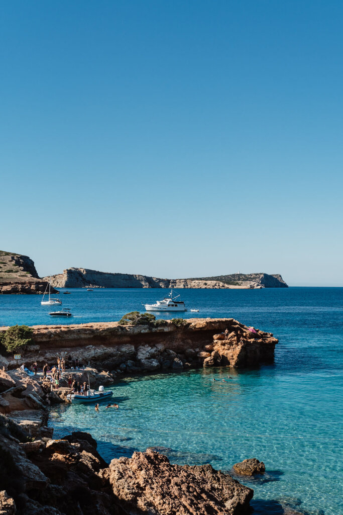 Turquoise water and rocky coastline at Cala Comte in Ibiza