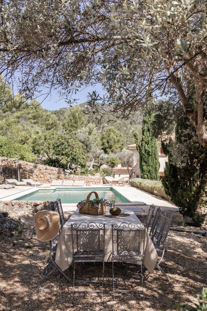 Outdoor dining area beside a swimming pool at a villa in Alaró, Mallorca