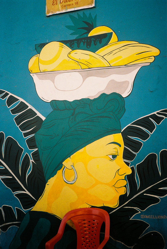 Colorful mural of a woman carrying a fruit basket in Cartagena, Colombia
