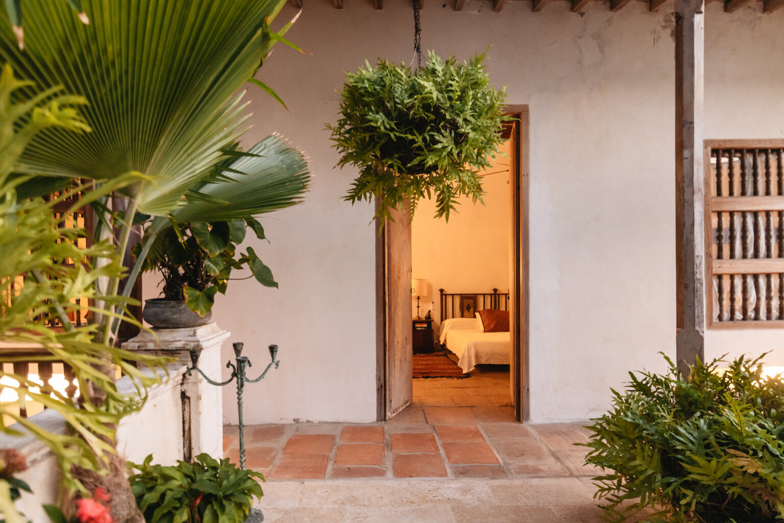 Tropical courtyard and bedroom at a luxury villa in Cartagena, Colombia