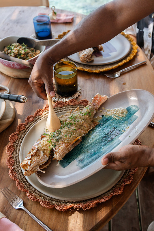 Freshly prepared fish served with herbs and local sides at a luxury villa in the Rosario Islands, Colombia