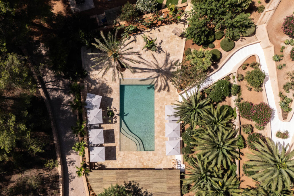 Aerial view of the swimming pool, parasols and landscaped grounds at Villa Lunara.
