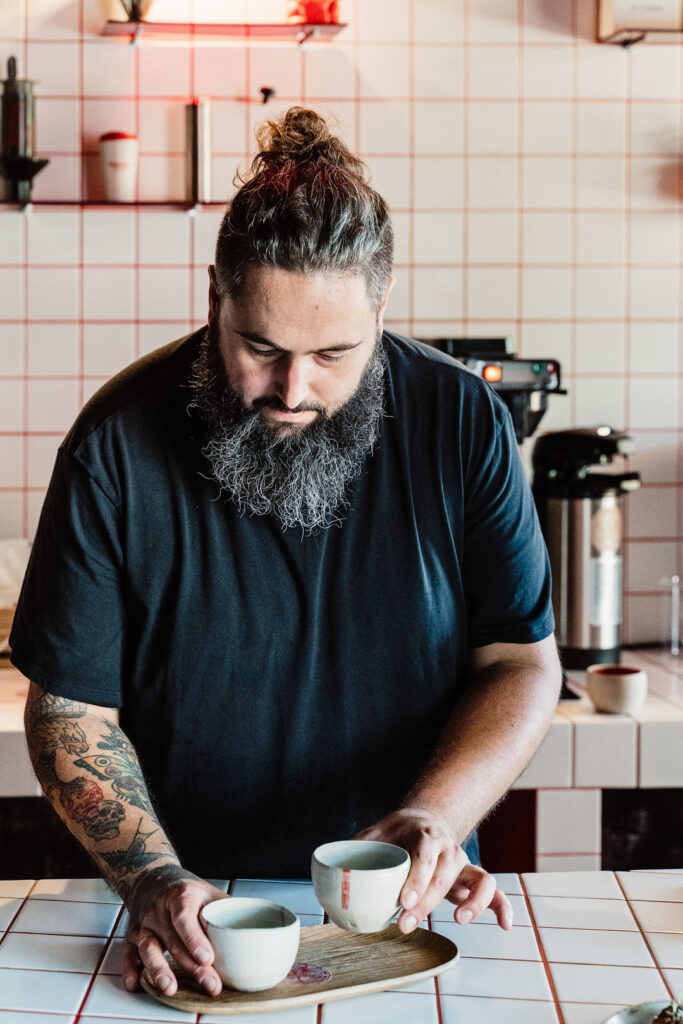 Owner Jorge serving coffee at Bagel House café in Santa Gertrudis, Ibiza