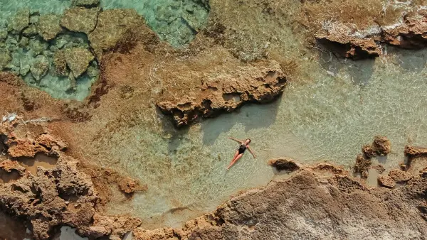 An aeriel shot of Marcia floating in the clear seas of Formentera