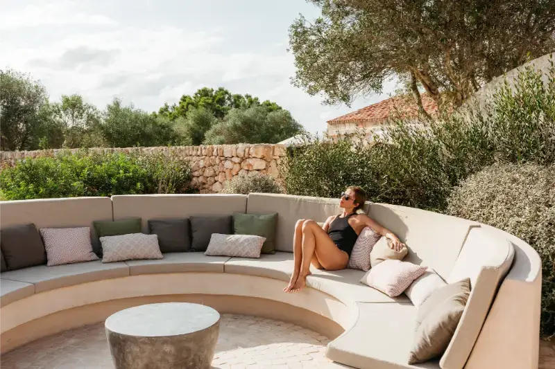 Relaxing in the sun on a plush long sofa on Santa Ana's pool terrace