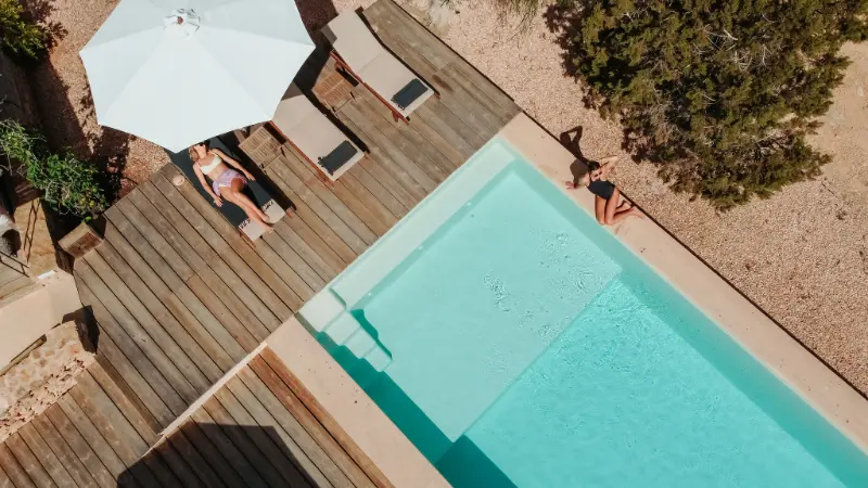 Sun shining onto the interior courtyard of Sa Parra over a sofa and cushions and wooden floor