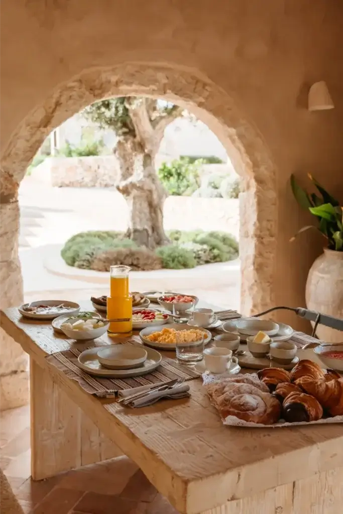 Breakfast spread on the Santa Ana shaded courtyard with views out over the olive tree