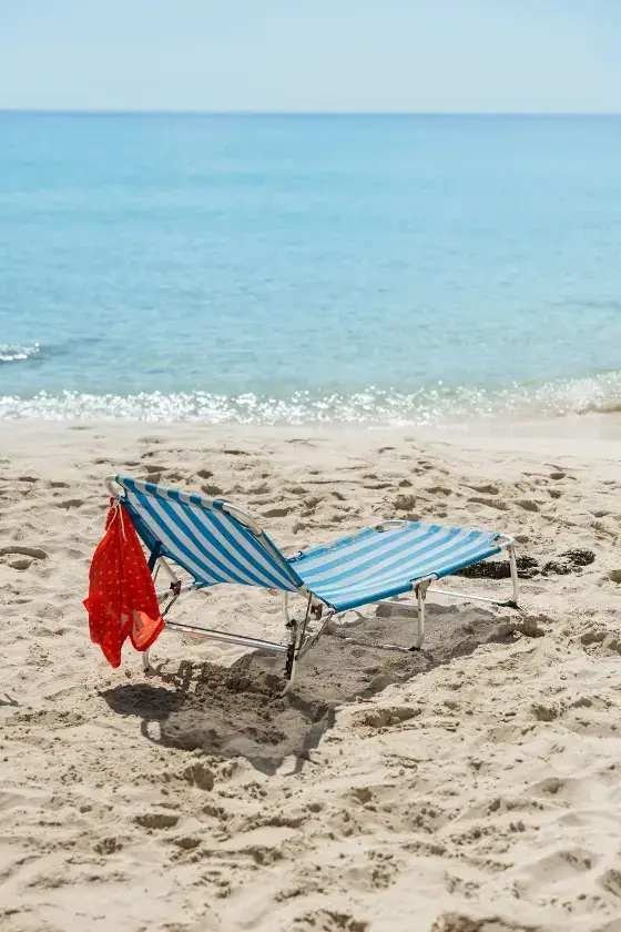Single sun lounger on the sand at Migjorn Beach in Formentera