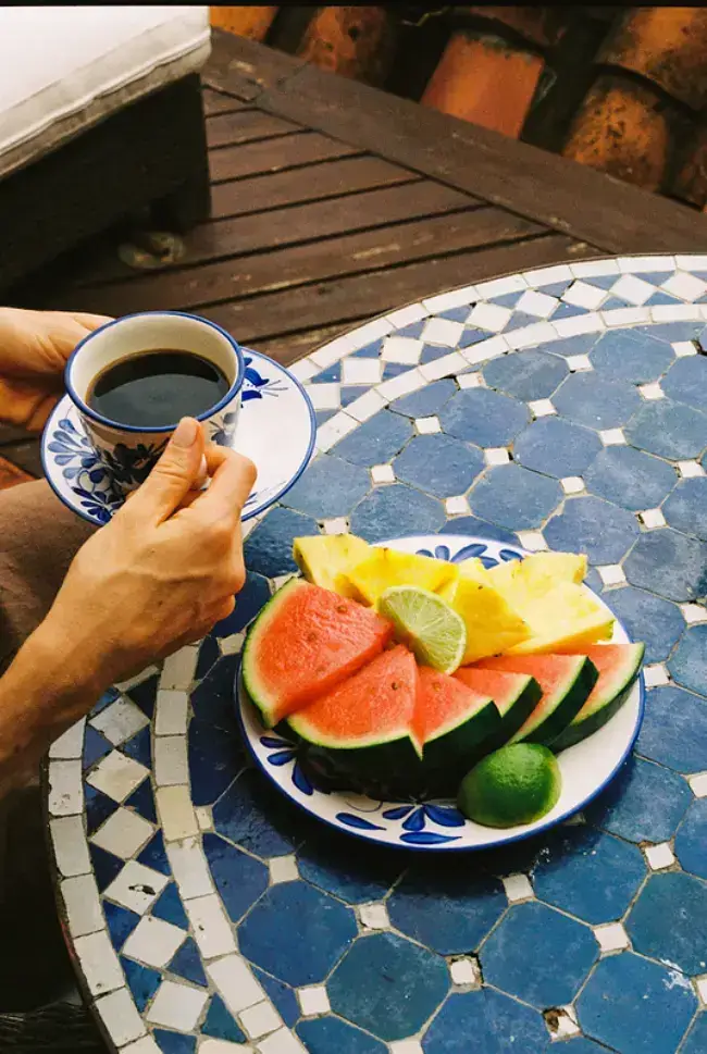 Cup of coffee and fresh tropical fruit served at a table in Antioquia, Colombia