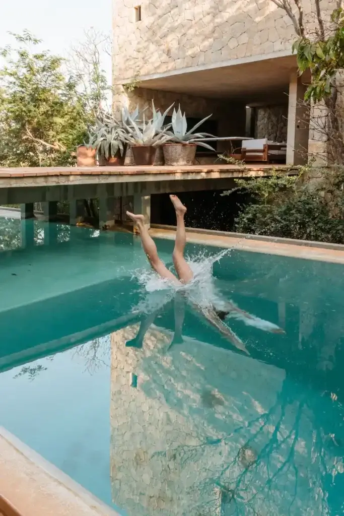 Person diving into the swimming pool at Casa Nahual in Mazunte, Mexico