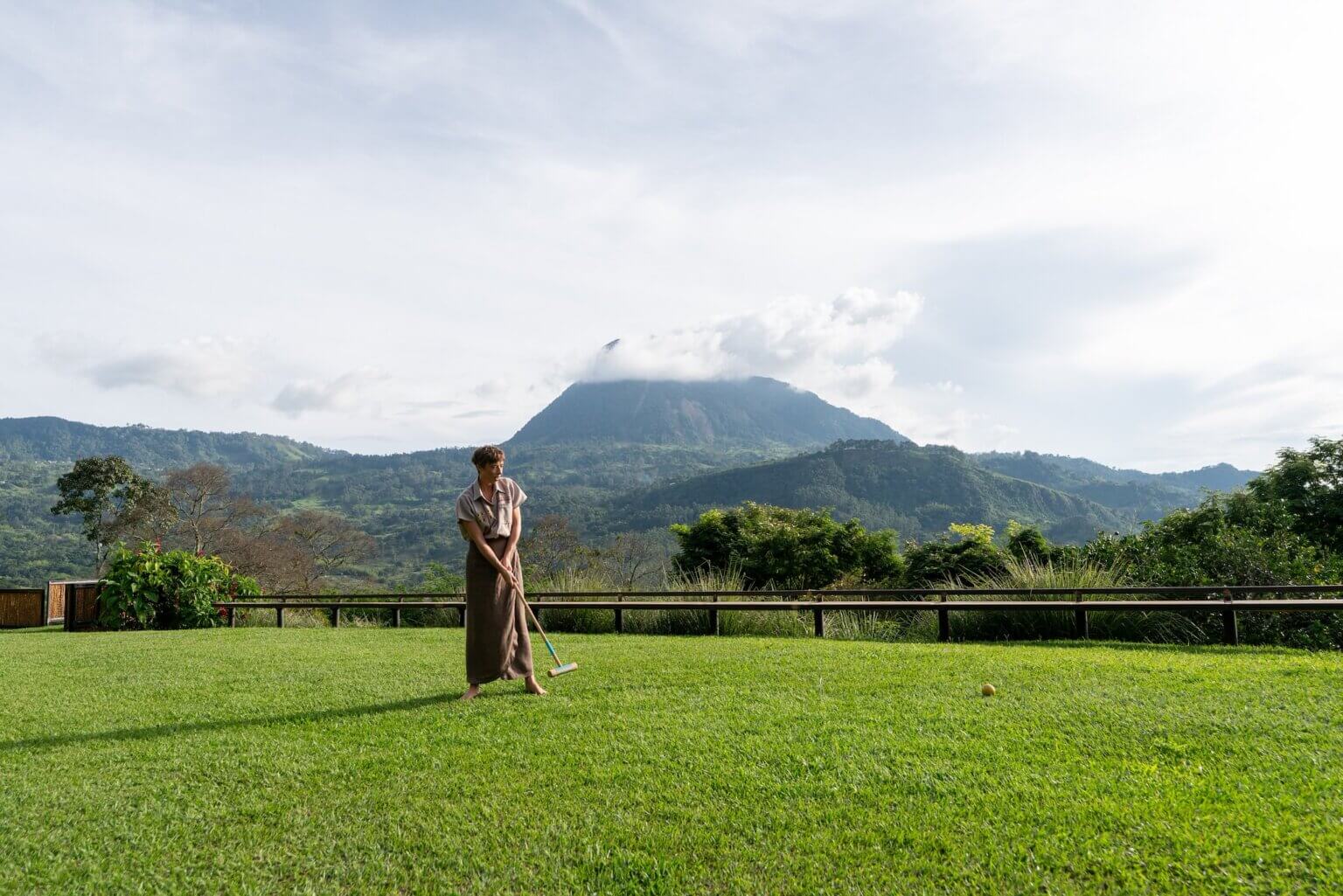 Woman playing on a green lawn of a luxury villa in Antioquia Colombia