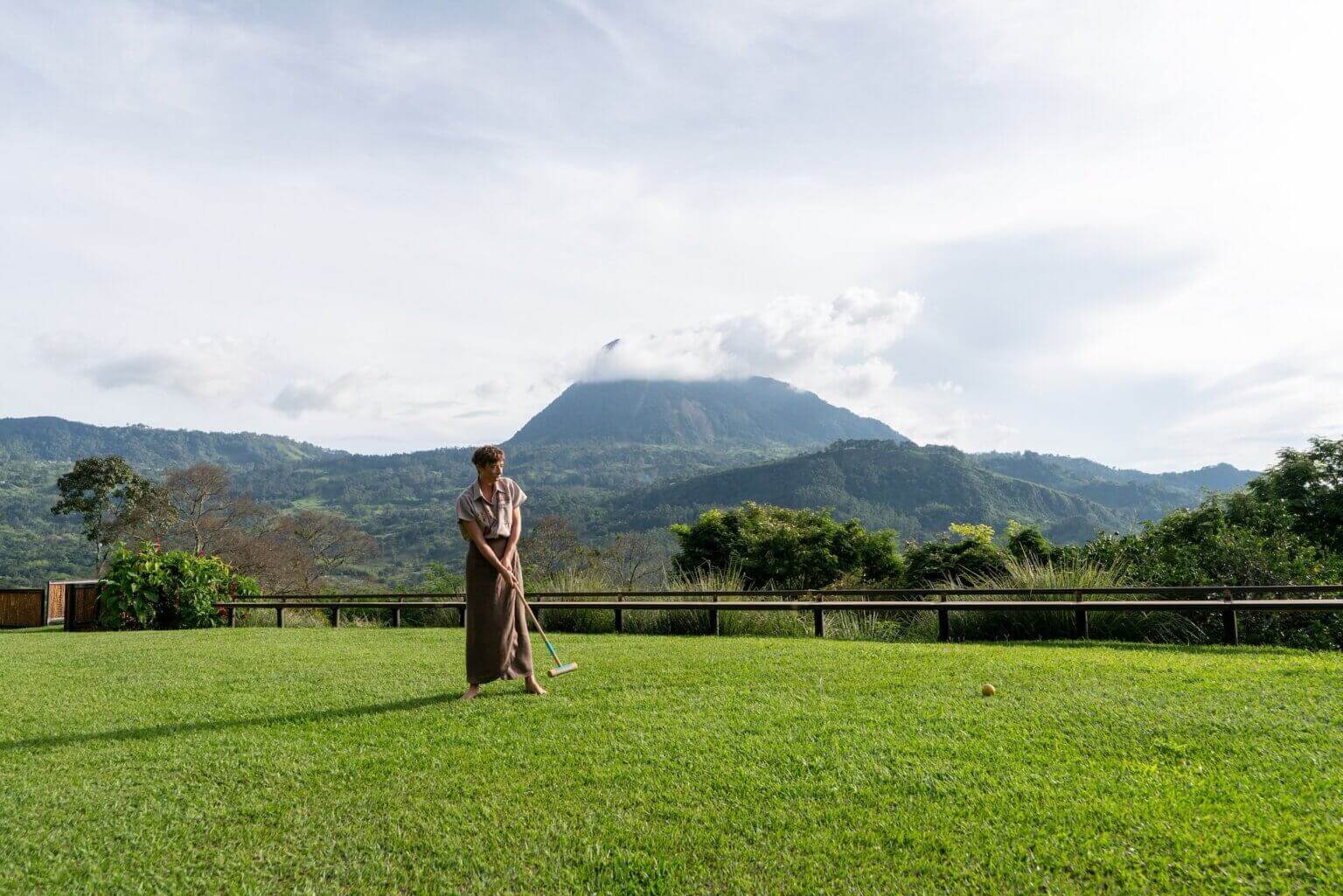 Woman playing croquet on the lawn at Hacienda Oro Molido in Antioquia, Colombia
