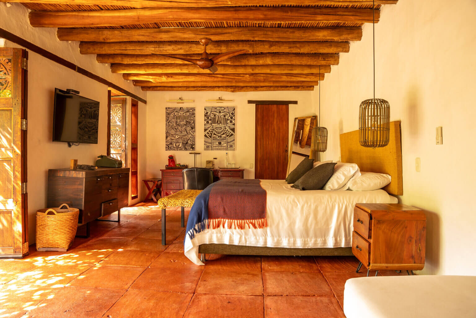 Bedroom with exposed wooden beams and traditional furnishings at Casa Siriri