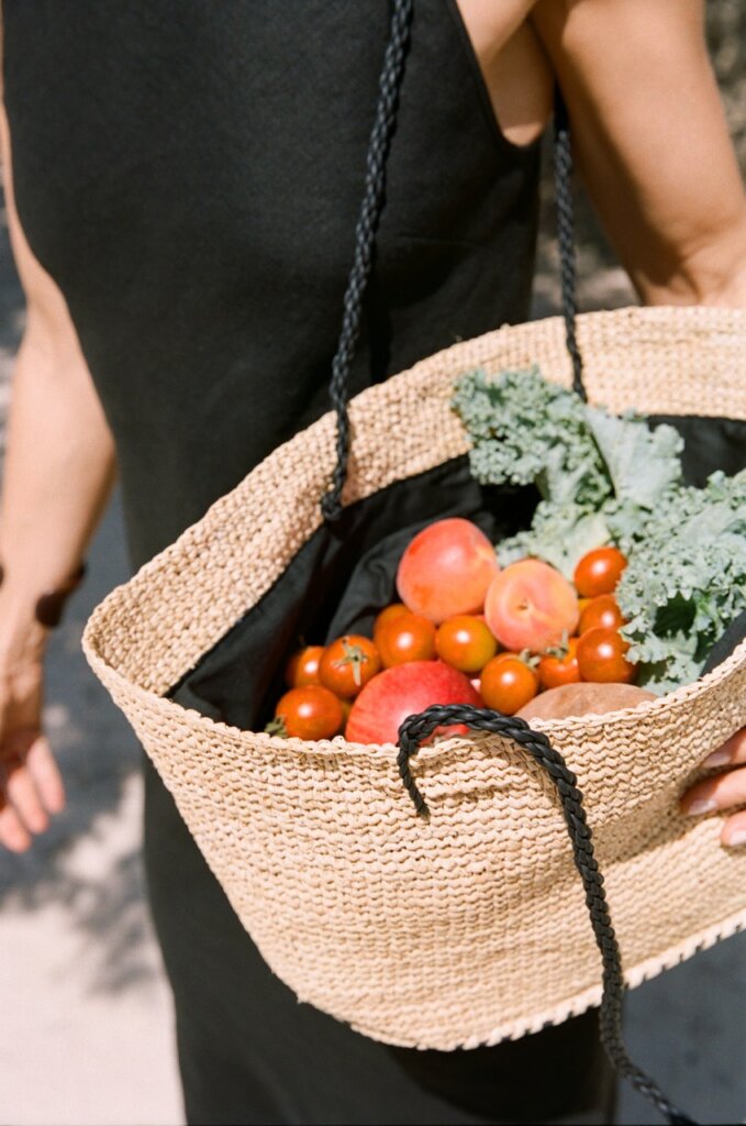 Woven basket filled with fresh fruit and vegetables during an Ibiza food market visit from Can Paloma villa.