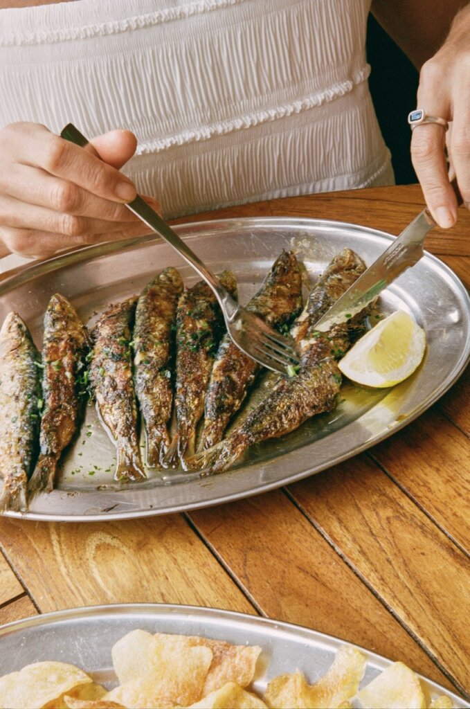 Grilled fish with lemon served at an outdoor restaurant during an Ibiza villa stay.