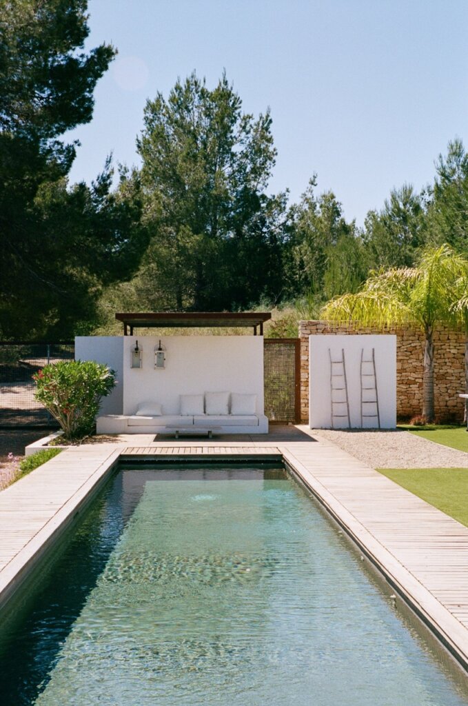 White shaded daybed beside the swimming pool at Can Paloma, Ibiza.