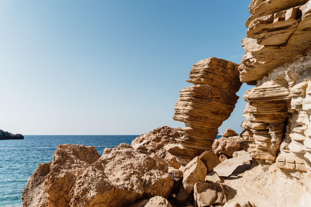 Dramatic flat rock formations and golden cliffs at Punta Galera, Ibiza, located a short distance from luxury Villa Anaïs.