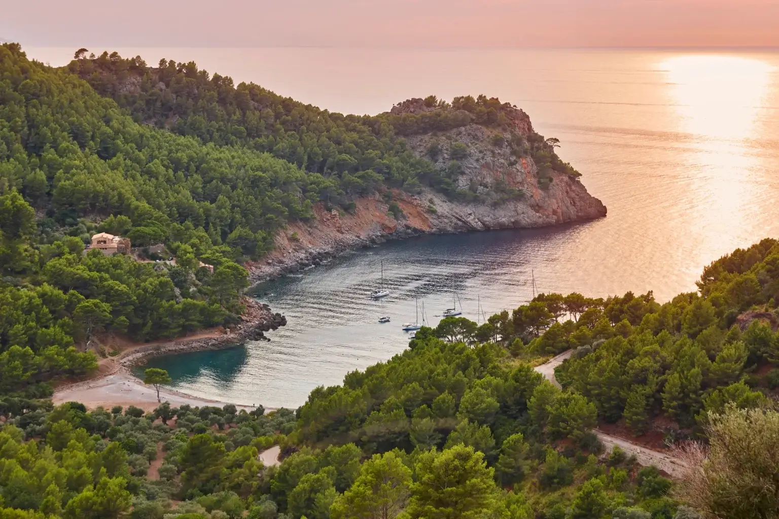 Cala Tuent with a sandy cove, turquoise Mediterranean water and mountain scenery in Mallorca, Spain