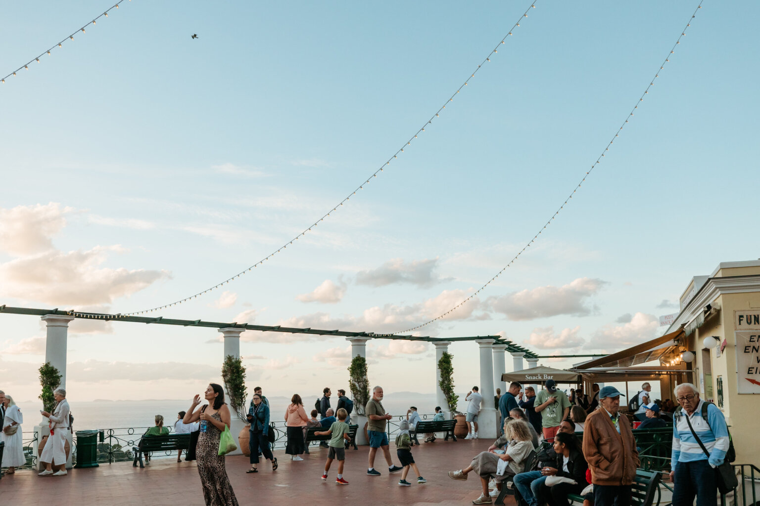 Visitors enjoying the panoramic sea view from a terrace in Capri