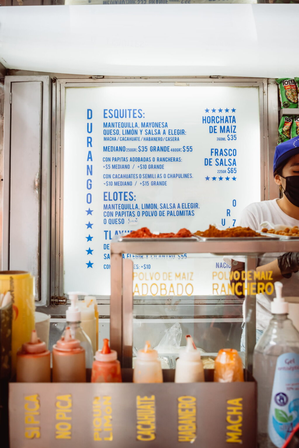 Mexican street food stand serving esquites and corn dishes in Mexico City