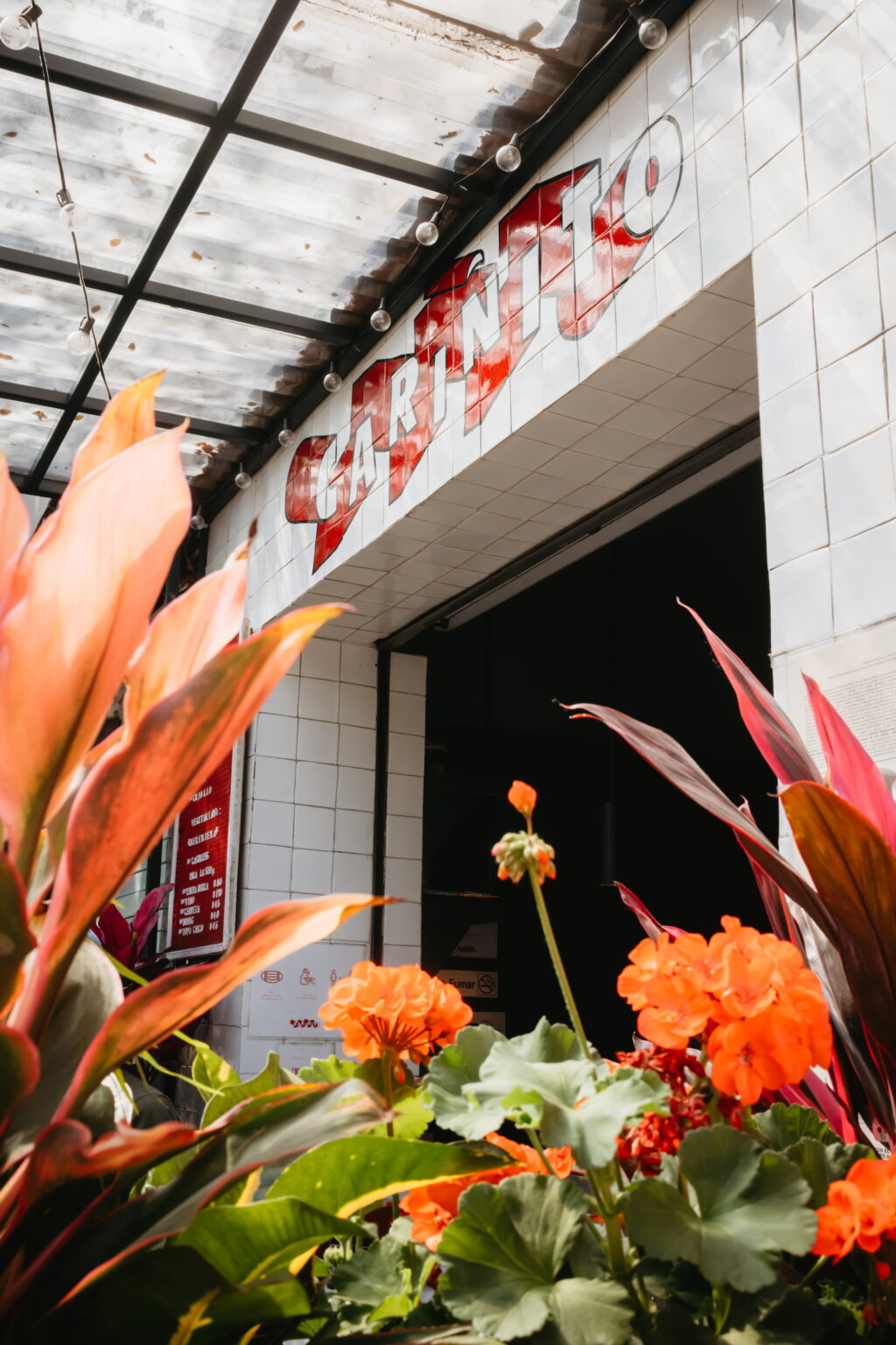 Colorful restaurant entrance surrounded by tropical plants in Mexico City