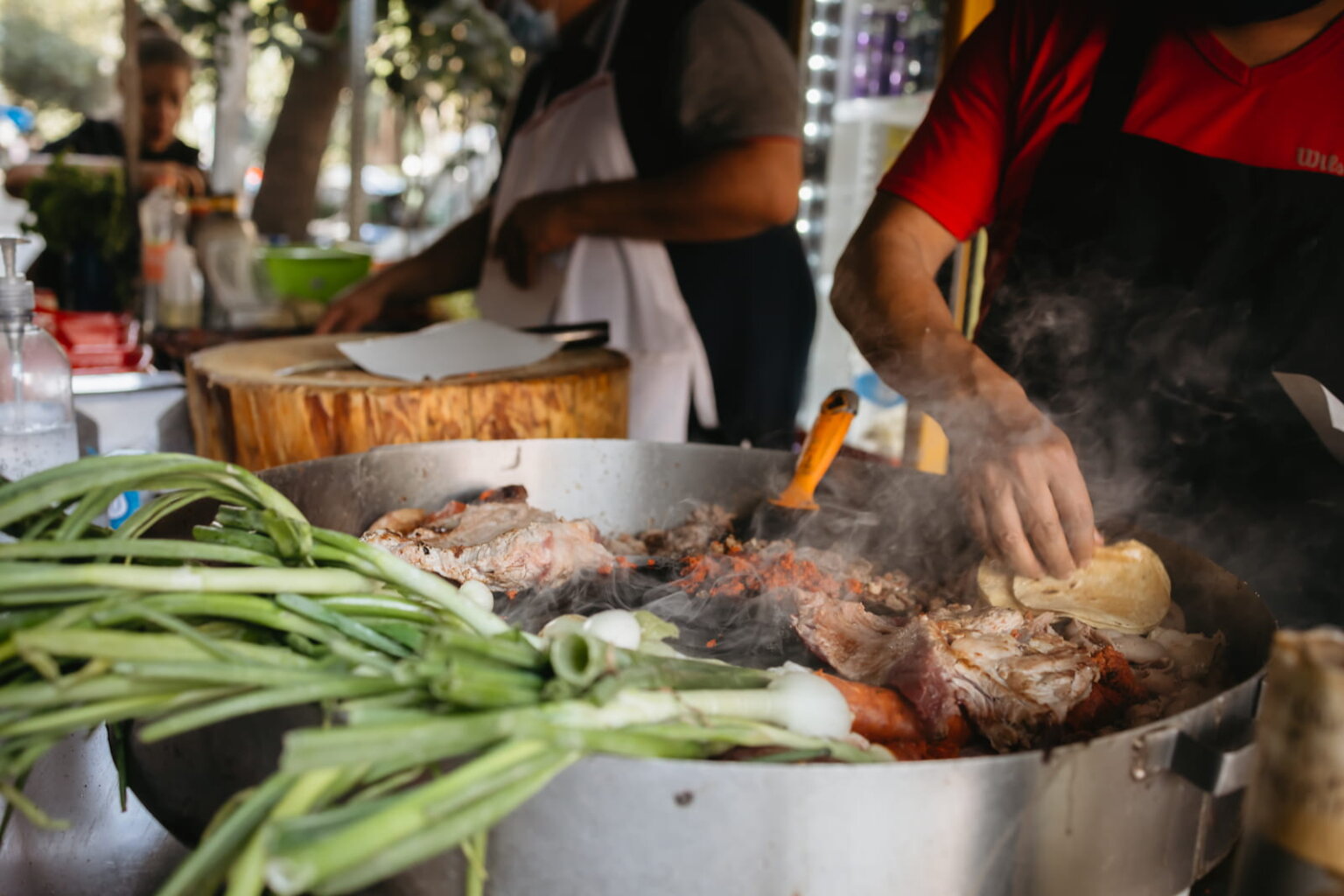 Street food vendors grilling meat and vegetables in Mexico City