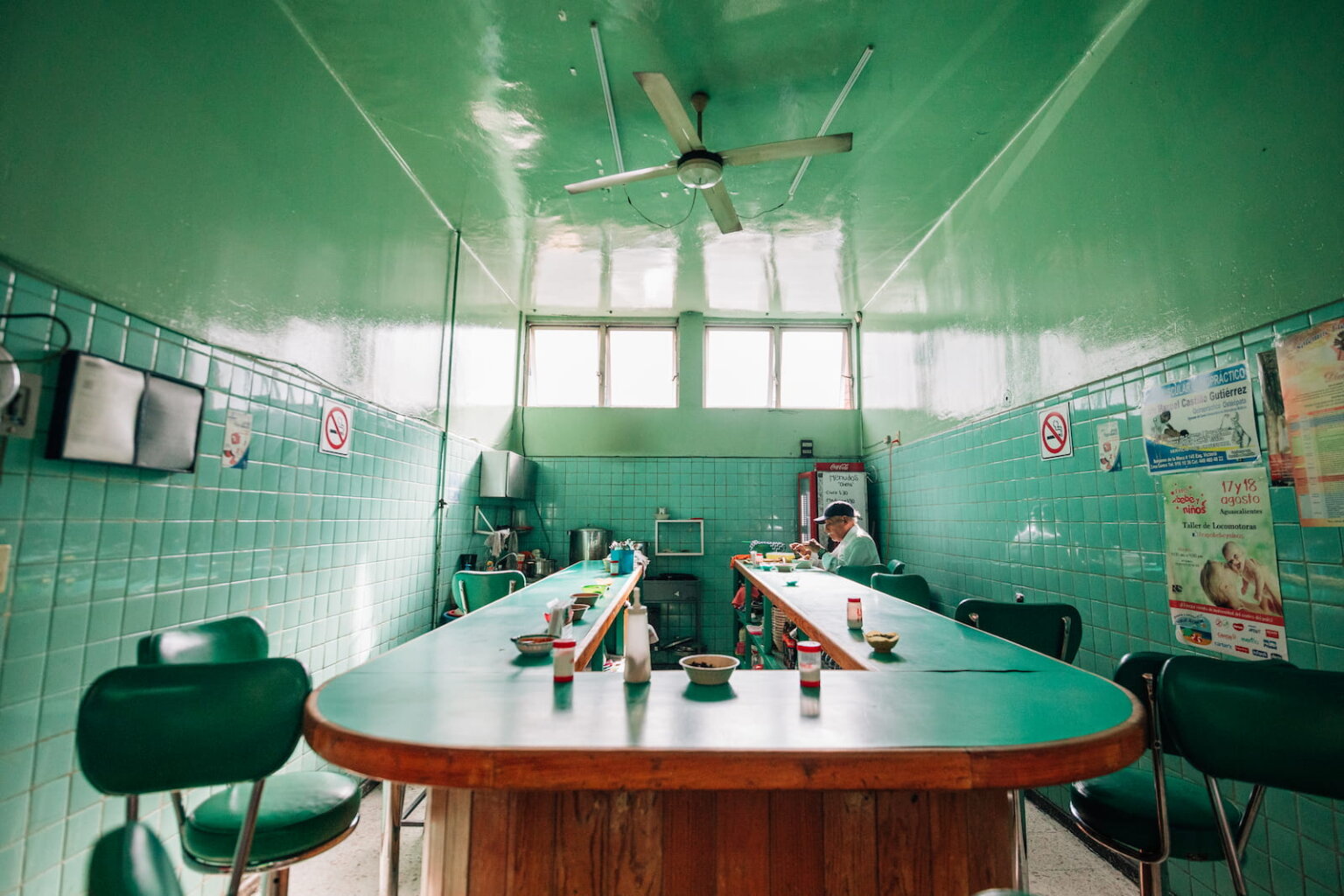 Traditional Mexico City restaurant interior with green tiled walls