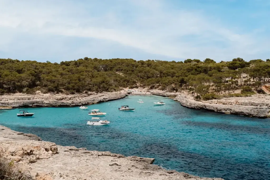 Cala Mondragó beach with clear turquoise water and a sandy shoreline in Mallorca, Spain