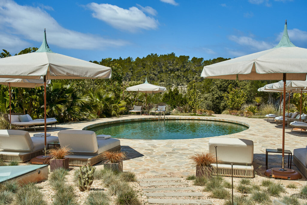 Fincadelica swimming pool surrounded by parasols and loungers